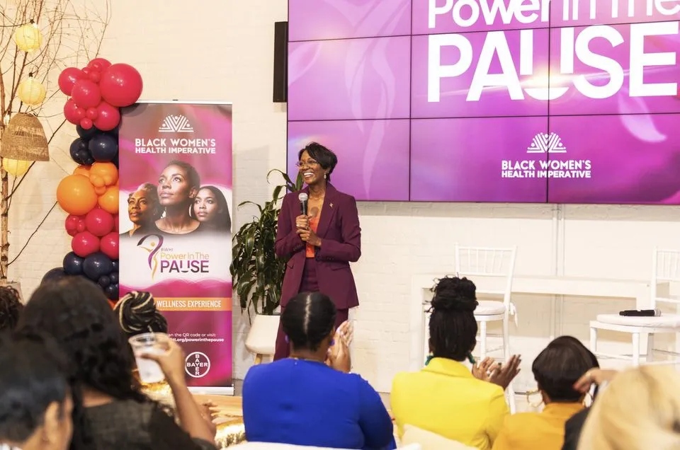 Kim speaking to an audience at a women's wellness event